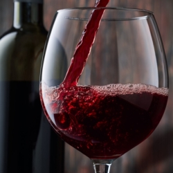 Red,Wine,Is,Poured,Into,A,Glass,From,A,Bottle